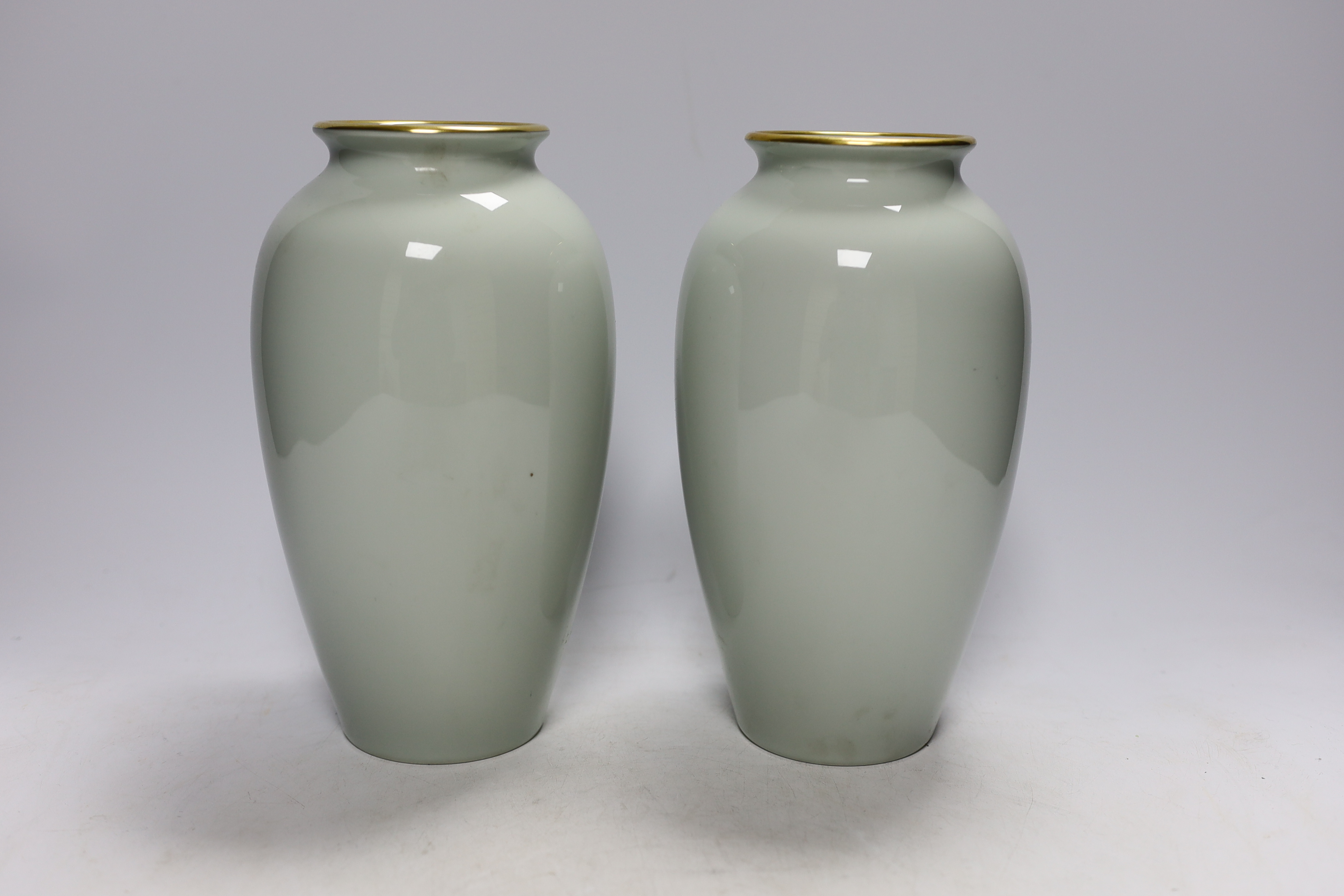 A pair of Japanese Fukagawa presentation vases, with Imperial sixteen petal chrysanthemum mon, probably a diplomatic gift, raised on hardwood stands, 25cm high